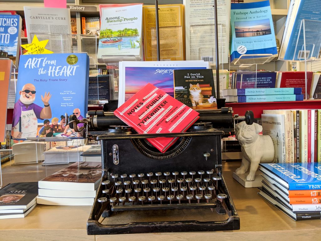 An old fashioned typewriter on a display with books
