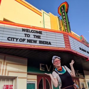 The author poses with the marquee of an historic, art deco-style theater marquee on a weekend getaway in New Iberia.